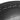 Close-up of black PU outer of an Xpeed round hit shield with visible stitching on a white background